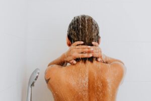 person's head and back are shown in while taking a shower micro moment